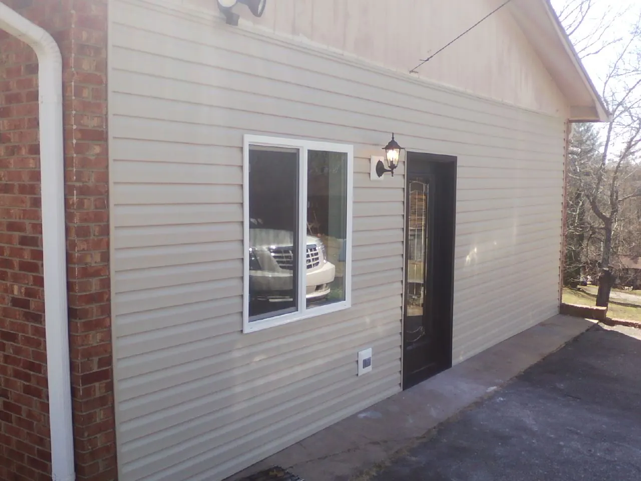 New vinyl siding and entry door on a room addition in Hamburg